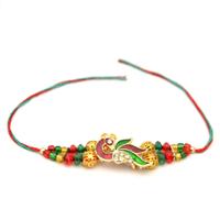 Artistic Peacock Rakhi with Red and Green Beads
