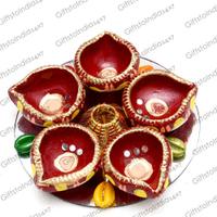 Beautiful Red Diyas On Silver Colored Plate