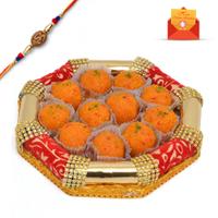 Ladoo In Golden Cuboid Shaped Tray With Rakhi