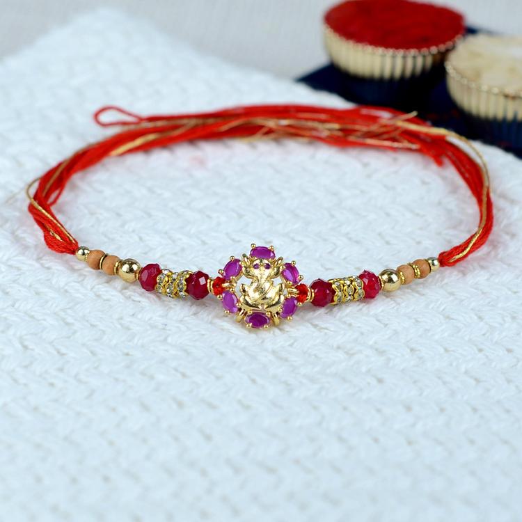 Magenta Stone Golden Ganesh Rakhi