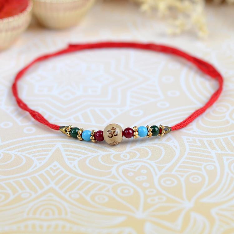 Single wooden bead with etched Om Rakhi