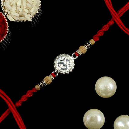 Real Silver Moulded Om Rakhi Red