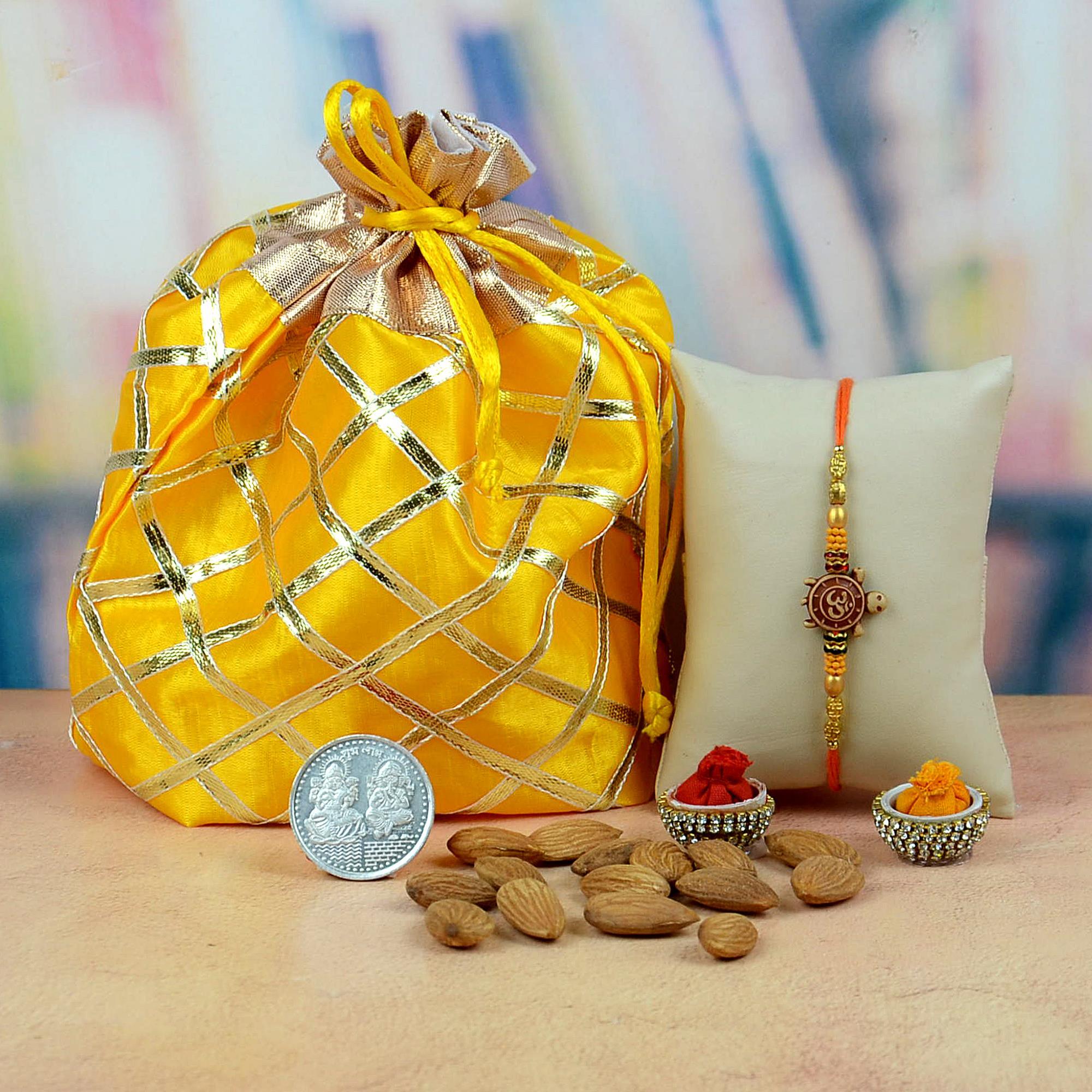 Almond with Om rakhi in Yellow Potli | Dryfruit Hampers
