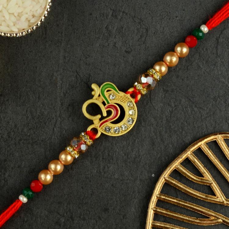 Golden Om with Subtle Ganesh Rakhi