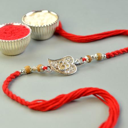 Glittering Silver Spade Om Rakhi