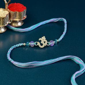 Glittering Om Lilac Blue Rakhi Glittering Om Lilac Blue Rakhi