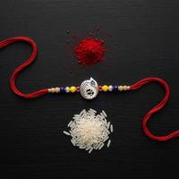 Om Peacock Feather Disc Rakhi