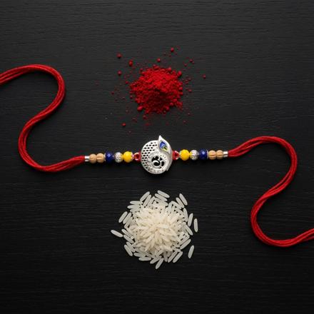 Om Peacock Feather Disc Rakhi