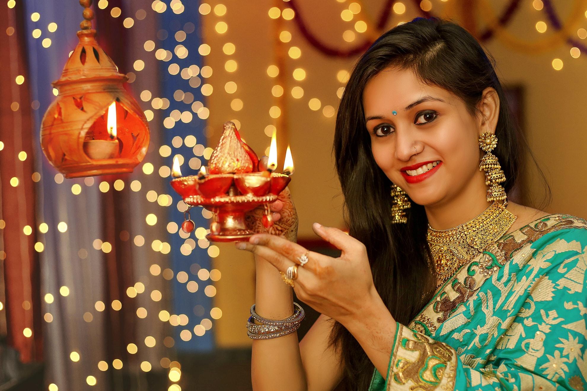 Free Photo | Scene photo of Indian woman kneeling by candles celebrating  Diwali